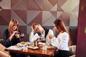 Young couple and mother. Indoors of new modern luxury restaurant photo