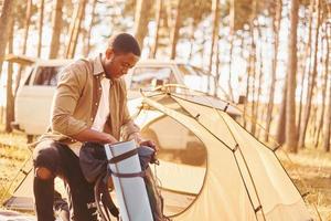 Man is traveling alone in the forest at daytime at summer photo