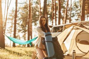 In the camp. Woman is traveling alone in the forest at daytime at summer photo