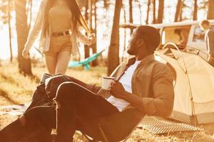 Leisure activities. Young couple is traveling in the forest at daytime together photo