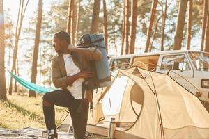 African american man is traveling alone in the forest at daytime at summer photo