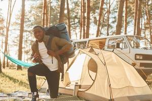 African american man is traveling alone in the forest at daytime at summer photo