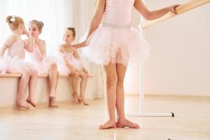 Practicing dance moves. Little ballerinas preparing for performance photo