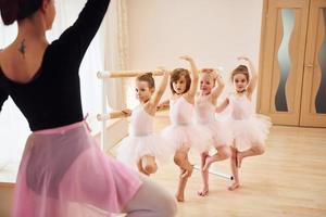 Practicing pose. Little ballerinas preparing for performance photo