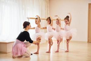 Practicing pose. Little ballerinas preparing for performance photo