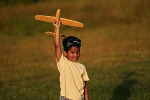 Weekend activities. African american kid have fun in the field at summer daytime photo