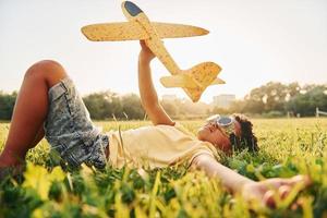 Beautiful summer daytime. African american kid have fun on the field photo