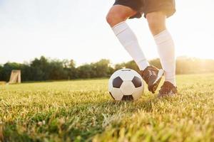 Close up view. Young soccer player have training on the sportive field photo