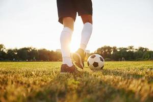 Close up view. Young soccer player have training on the sportive field photo