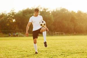 One person only. Young soccer player have training on the sportive field photo