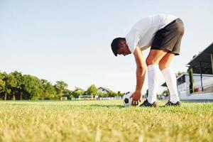 Preparing for the game. Young soccer player have training on the sportive field photo