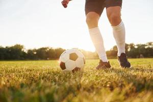 Close up view. Young soccer player have training on the sportive field photo