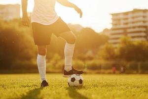 Beautiful sunshine. Young soccer player have training on the sportive field photo