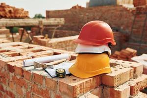 Close up view of protective hard hats that laying down on the bricks photo