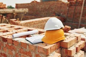 Close up view of protective hard hats that laying down on the bricks photo