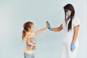 Procedure is done. Doctor in uniform making vaccination to the patient photo