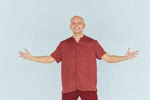 Man in red casual shirt is standing against white background photo