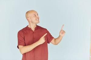 Man in red casual shirt is standing against white background photo