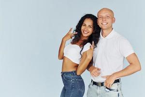 Smiling and posing for the camera. Cheerful couple is together indoors photo