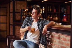 Having a rest. Man in casual clothes sitting in the pub photo