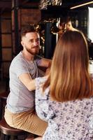 Talking with each other. People in casual clothes sitting in the pub photo