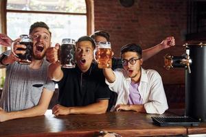 Soccer fans. People in casual clothes sitting in the pub photo