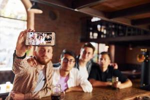 Weekend activities. People in casual clothes sitting in the pub photo