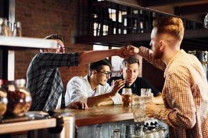 Having fun at weekend. People in casual clothes sitting in the pub photo