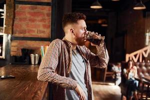 Weekend relax. Man in casual clothes sitting in the pub photo