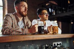 Talking with each other. People in casual clothes sitting in the pub photo