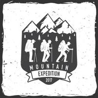 Vintage typography design with mountaineers and mountain silhouette. vector