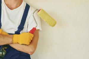 Builder at his job. Young man working in uniform at construction at daytime photo