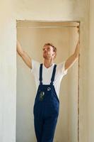 Modern technologies. Young man working in uniform at construction at daytime photo