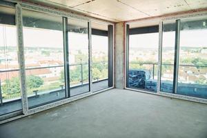 Empty unfinished room on construction site at daytime. Conception of business photo