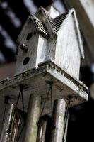 Abstract bird house windchime dirty and weathered photo