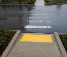 Rainy day cross walk with yellow traction pads photo