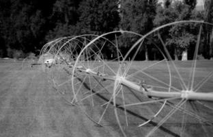 Golf course irrigation wheels in black and white photo