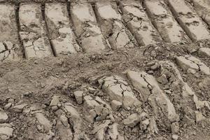 ATV tire tracks side by side in the dirt photo