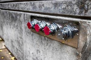 Fire hose nozzles on a building wall photo