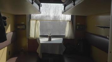 Metal cup holder on a table in a compartment of a fast train video