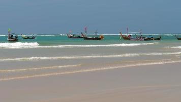 Longtail fishers boats parked in Mai Khao beach near fishers village in Phuket island. Thailand video