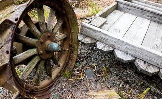 Vintage antique automotive tractor wheel covered in rust photo