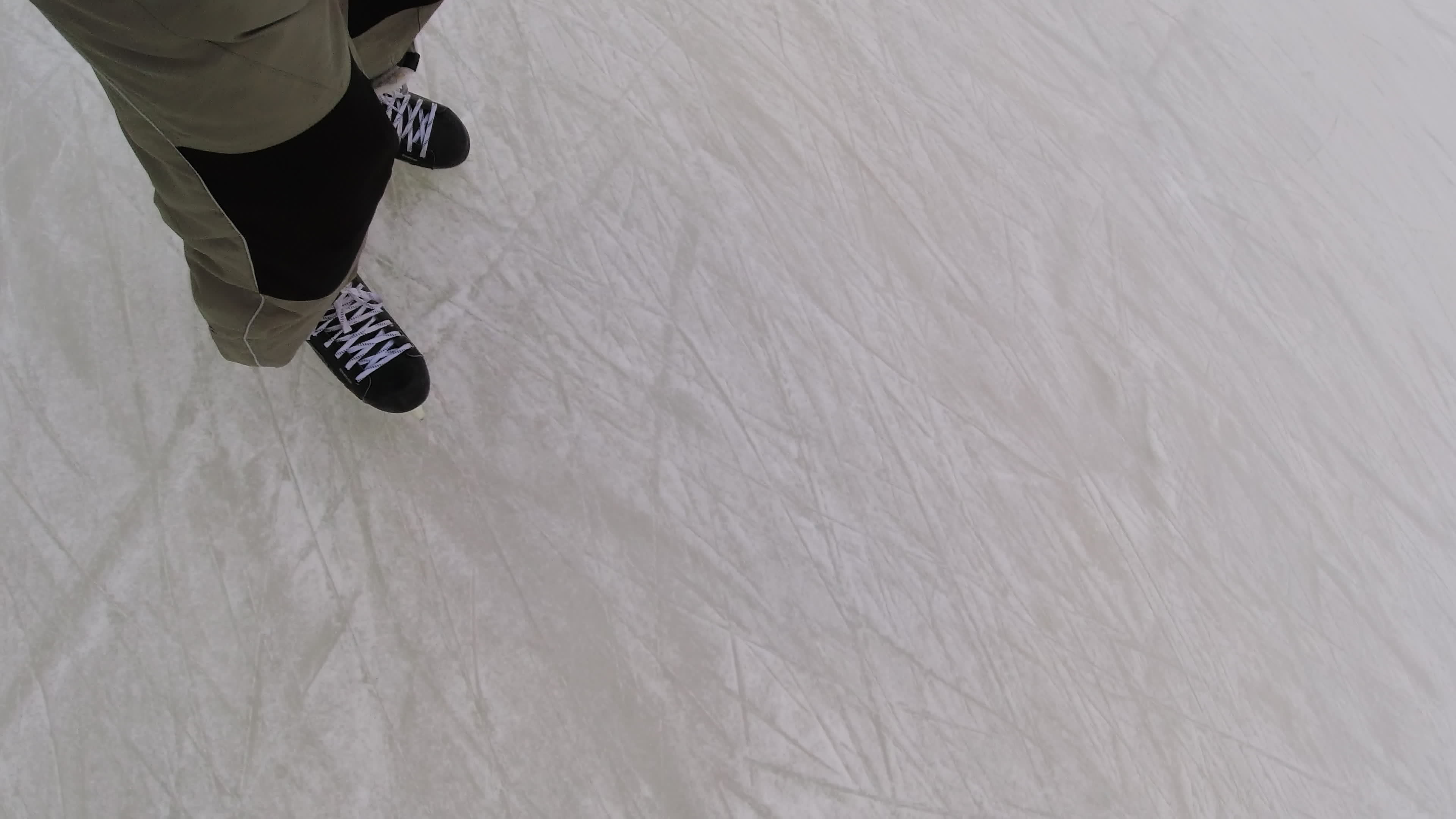 Man skating on a frosty winter day. Ice skating, first person view of