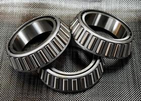 3 automotive tapered roller bearings on carbon fiber. photo