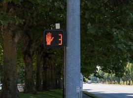 Crosswalk hand symbol sign on a post photo