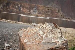 Red desert stone with river and cliff in the background photo