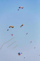 Colorful kites flying in the sky against a blue sky photo