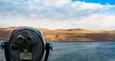 Scenic desert river view showing coin-op binoculars photo