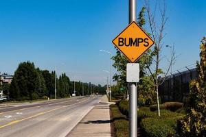 Bumps road sign next to an industrial byway photo