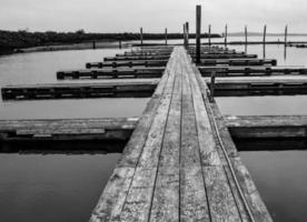 Black and white boat dock in a calm harbor photo